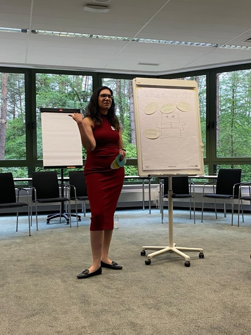 Bar Schwartz running a workshop, beside a flipchart headed What is AI?
